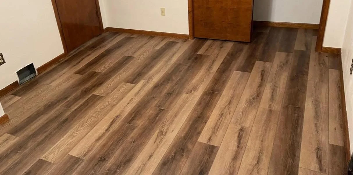 Mixed-tone brown wood-look planks in a room with wooden doors