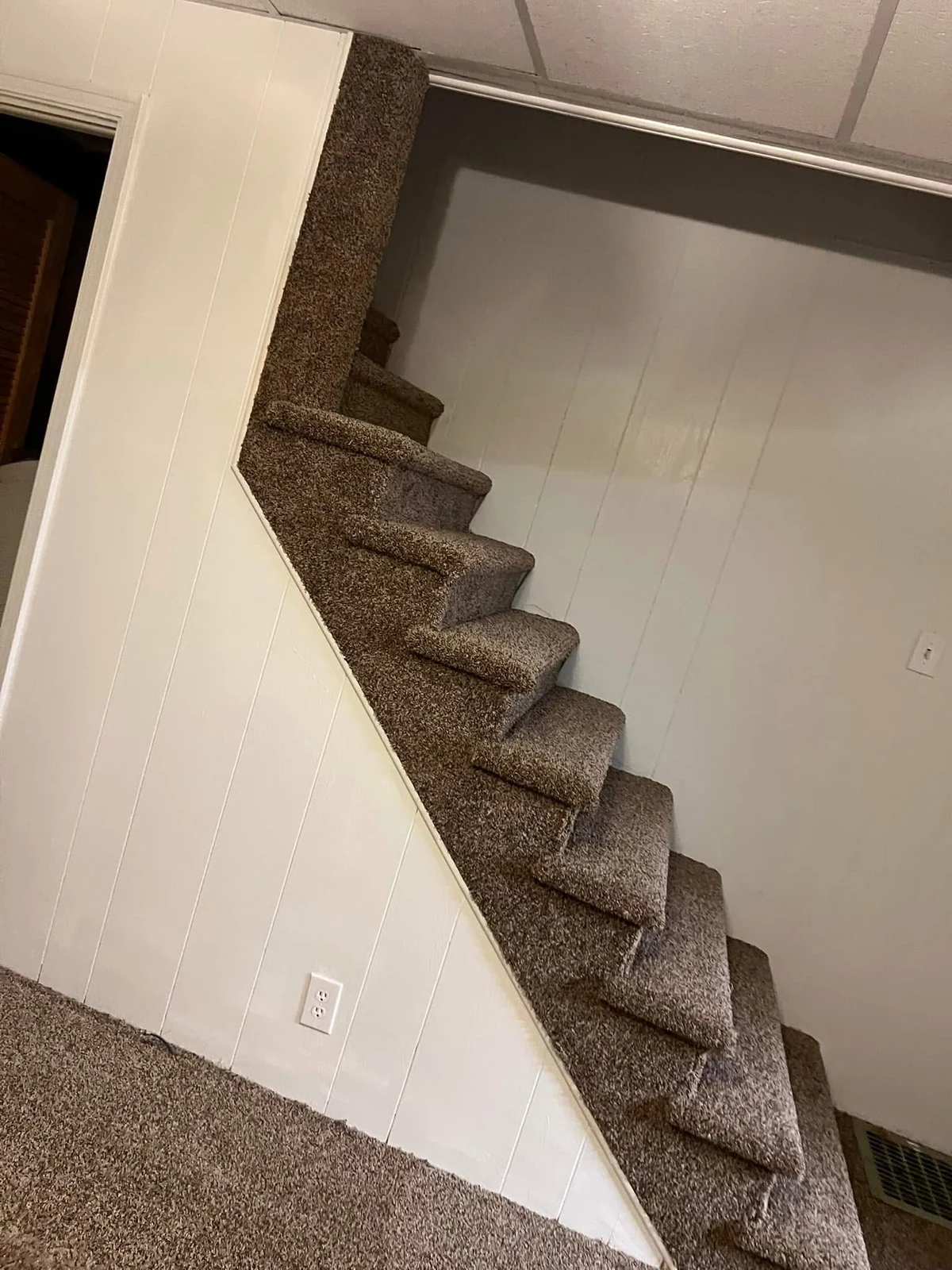 Textured carpet fitted to a basement staircase, viewed from the side